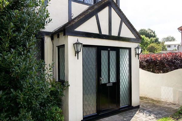 Black aluminium traditional front door with leaded glass and side panels from the Anglian front door range