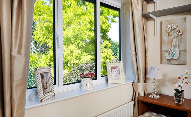 White aluminium double glazed windows with side hung casements and white handles from Anglian Home Improvements