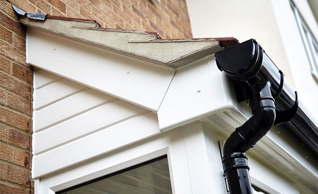 Black uPVC guttering and White contrasting colour soffits and fascias on a porch from Anglian Home Improvements