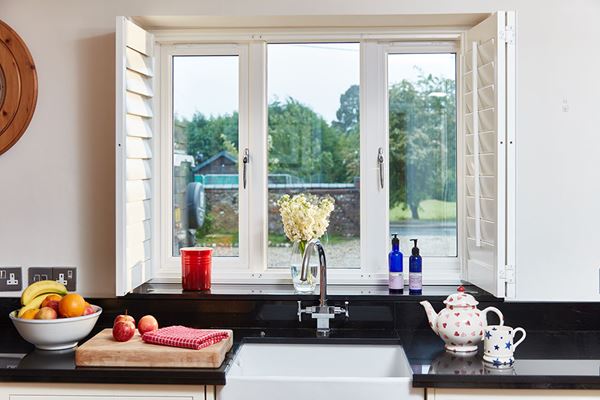 Replacement UPVC double glazed window for kitchen finished in dual White and Cream from Anglian Home Improvements