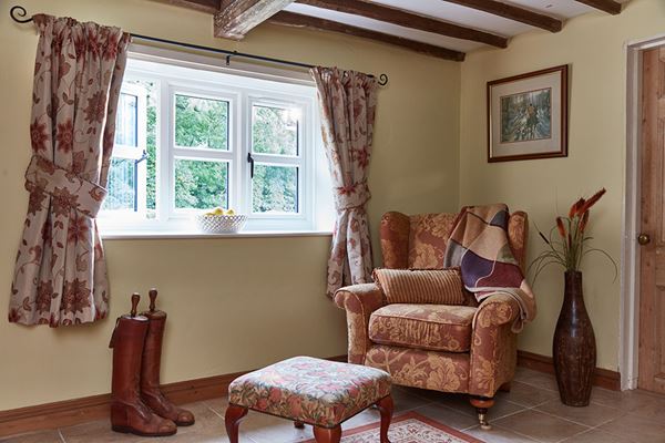 UPVC Stormproof double glazed casement window finished in dual White and Sage Green from the Anglian double glazed window range