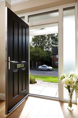 Traditional composite front door finished in Jet Black opening onto front garden from Anglian Home Improvements