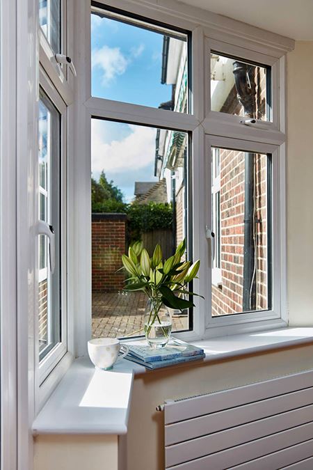 Triple glazed UPVC casement windows finished in White on porch from Anglian Home Improvements