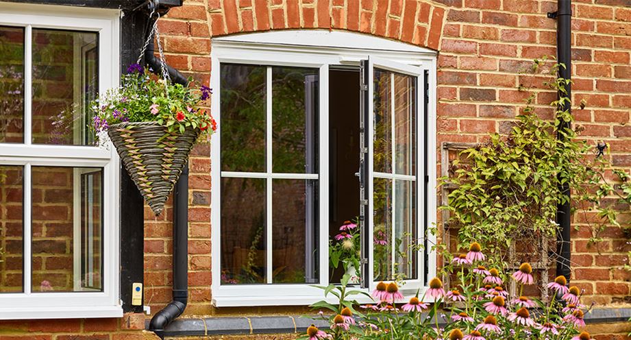 white casement window with Georgian bar inserts in open position