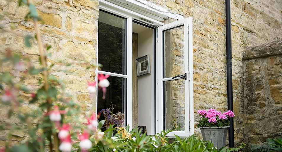 White Timber Casement Window with Black Handles and Central Horizonal Astragal Bars Open on One Side