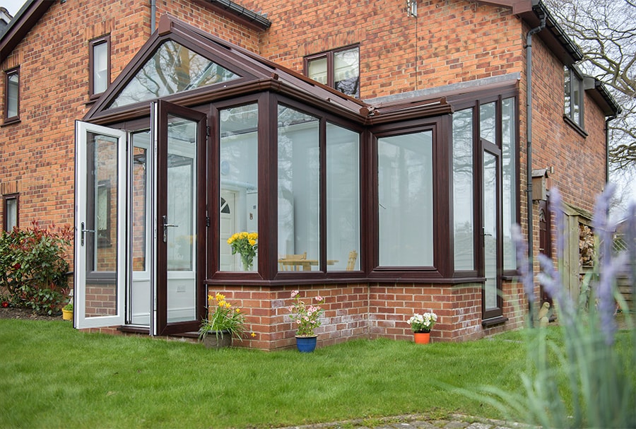 Dual dark brown harmoney conservatory with triangle top window