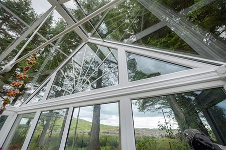 Triangle window in conservatory interior close up