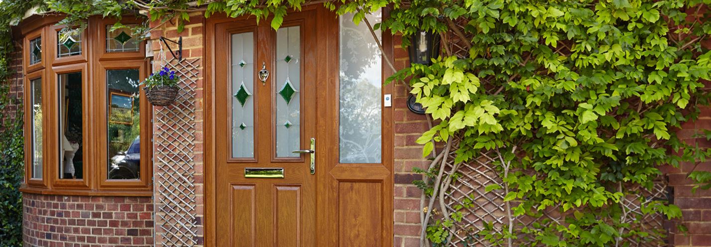 Golden oak bay windows and composite door with etched stained glass banner