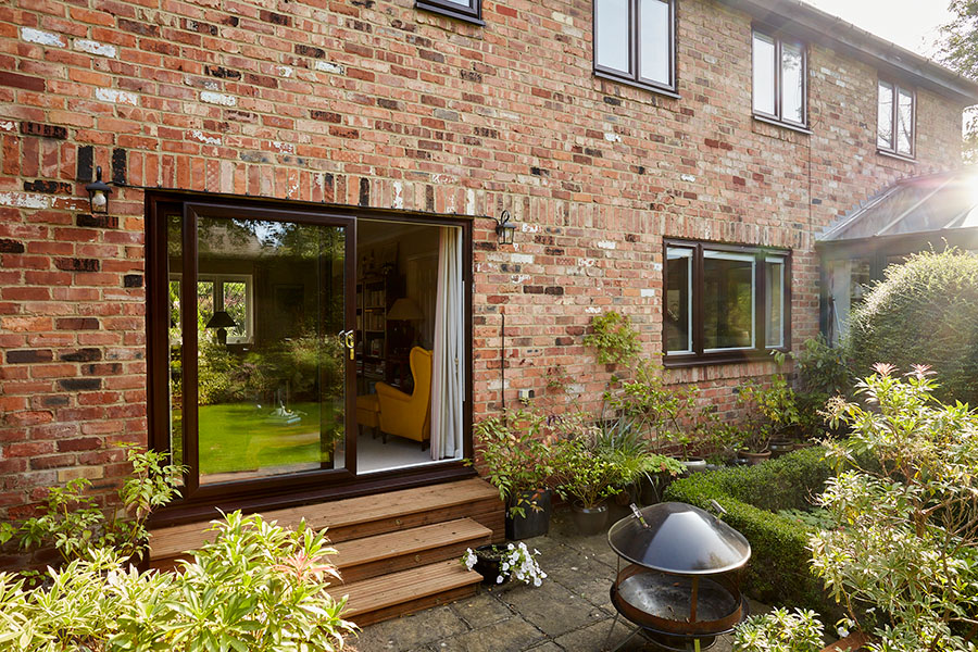Dark woodgrain uPVC patio doors with matching casement windows