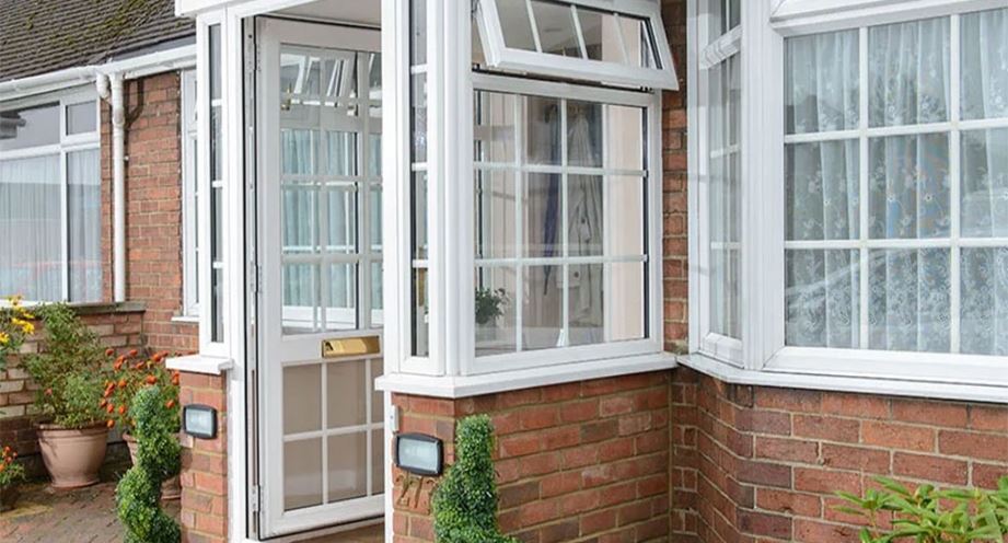 White uPVC porch and windows with Georgian bars in open position banner