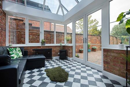 White uPVC Elizabethan conservatory with solar glass roof and Georgian bars interior