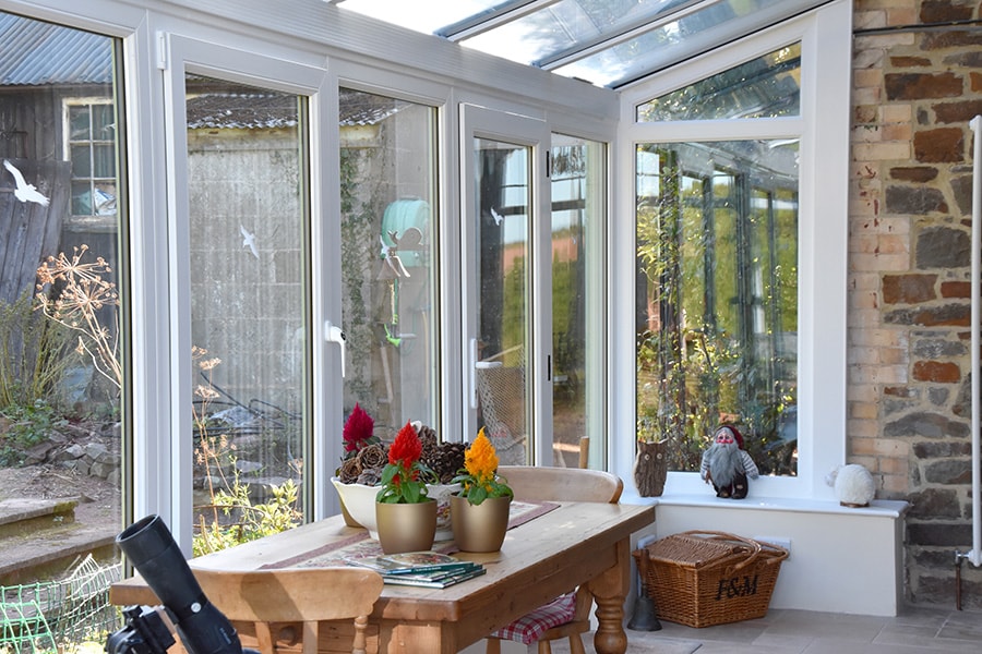 Dual sage green L shaped harmony conservatory interior