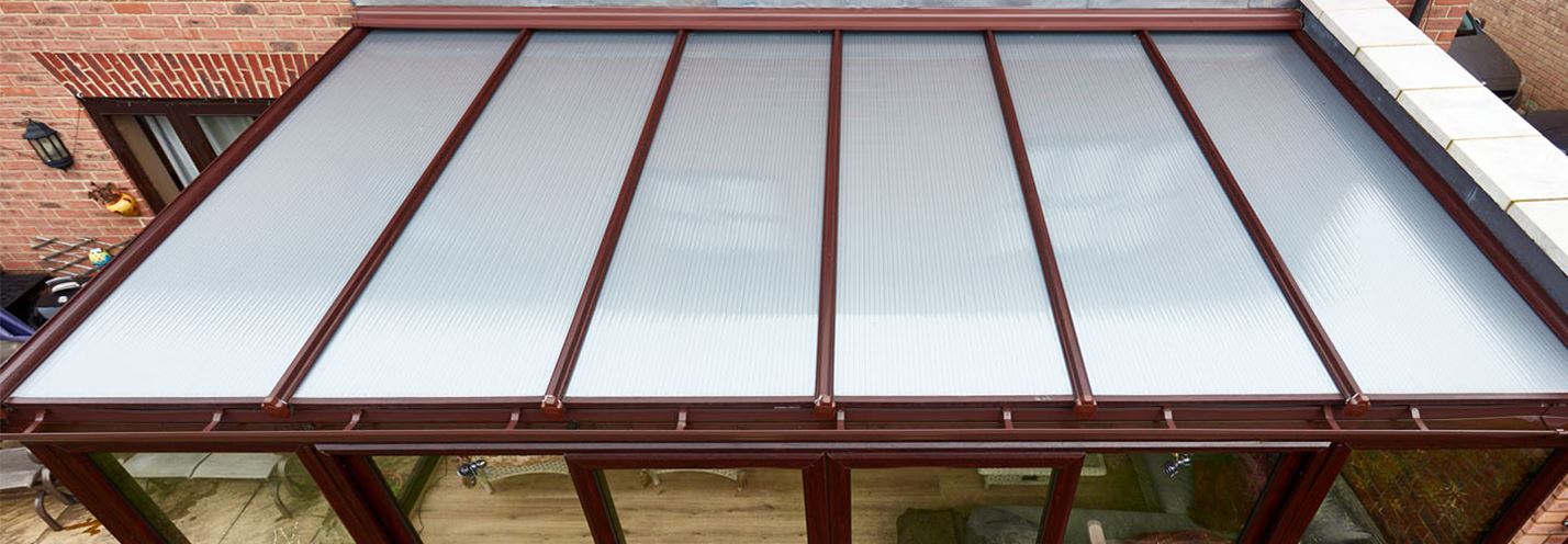 Dark woodgrain uPVC lean to with polycarbonate roof banner