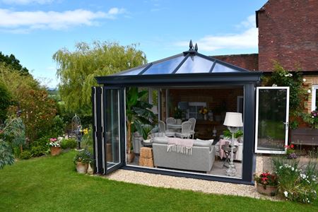 Modern anthracite grey Orangery with aluminium bifold doors on two sides