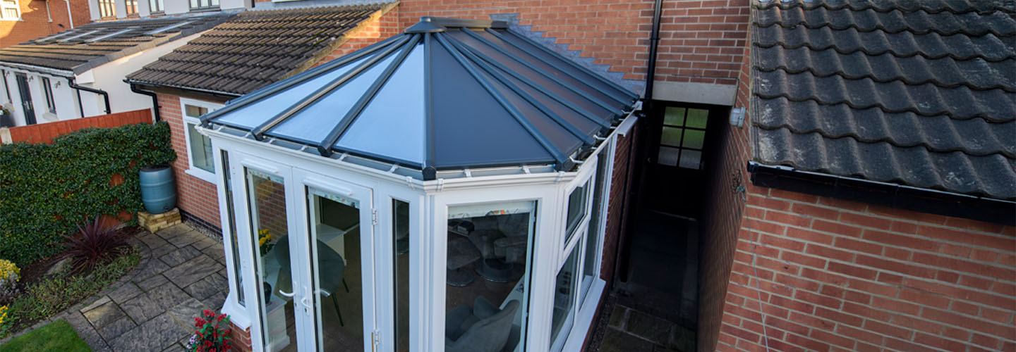 White uPVC stretched Victorian conservatory with solid panel roof