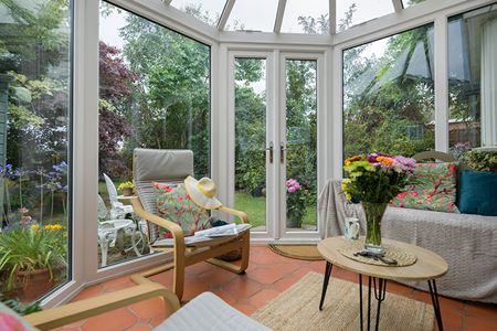 Dual sage green uPVC Victorian conservatory with French doors