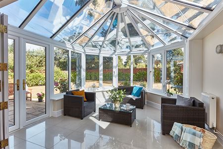 Large white uPVC Victorian conservatory with French doors interior