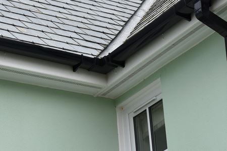 Black guttering and white bargeboard corner point