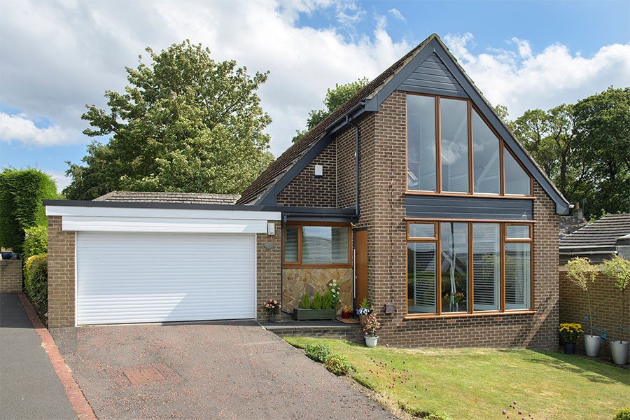 Black uPVC bargeboard with golden oak windows whole house