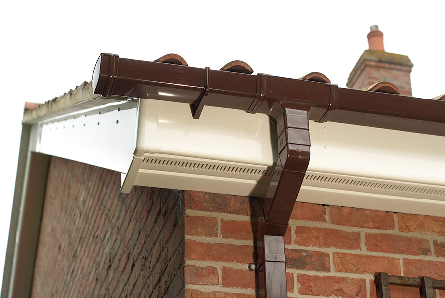 White uPVC bargeboard with brown guttering close up