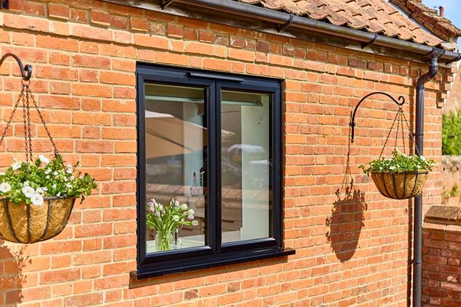 Black aluminium casement window at back of house