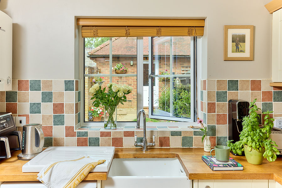 White Aluminium casement window with Georgian insert bars in kitcejn open position