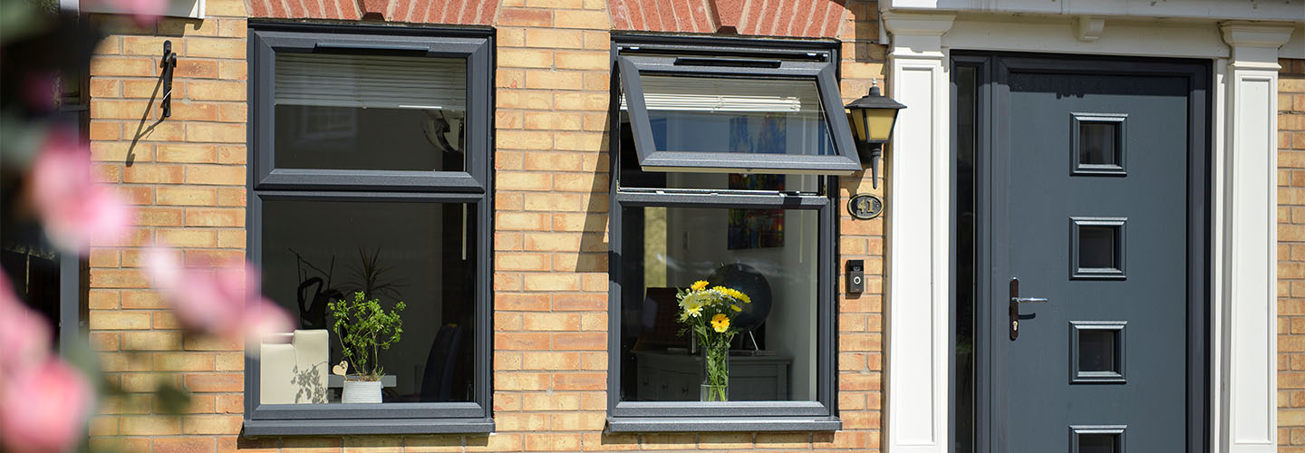 Anthracite grey uPVC top hung casement and front door energy efficiency banner