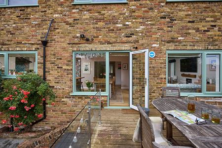 Dual sage green uPVC casement windows and single back door