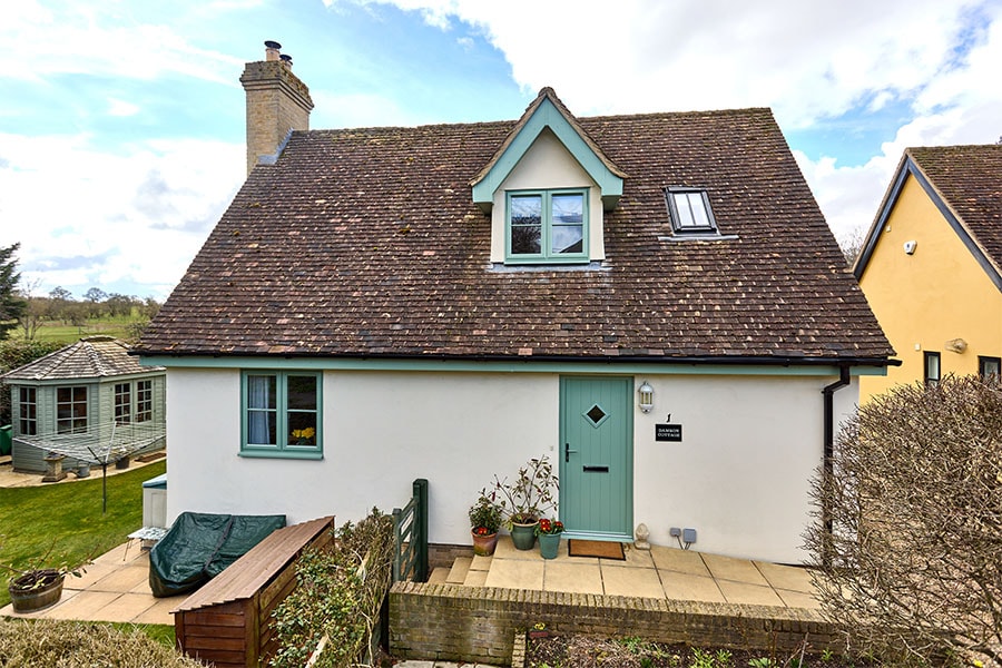 uPVC casement windows with cottage bars in sage green with cladding and front door matching
