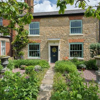 Dual sage green uPVC sash windows front of house