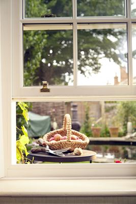 Close up of white timber sliding sash window with double glazing and cottage bars from Anglian Home Improvements
