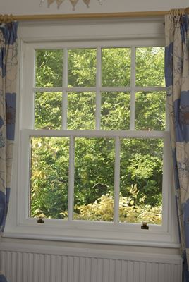 Interior view of white double glazed wooden sash window with cottage bars from Anglian Home Improvements