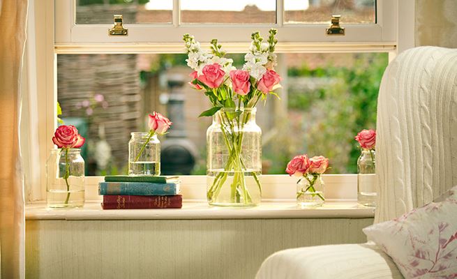 Close up of white wooden double glazed sash window with gold sash pull window furniture